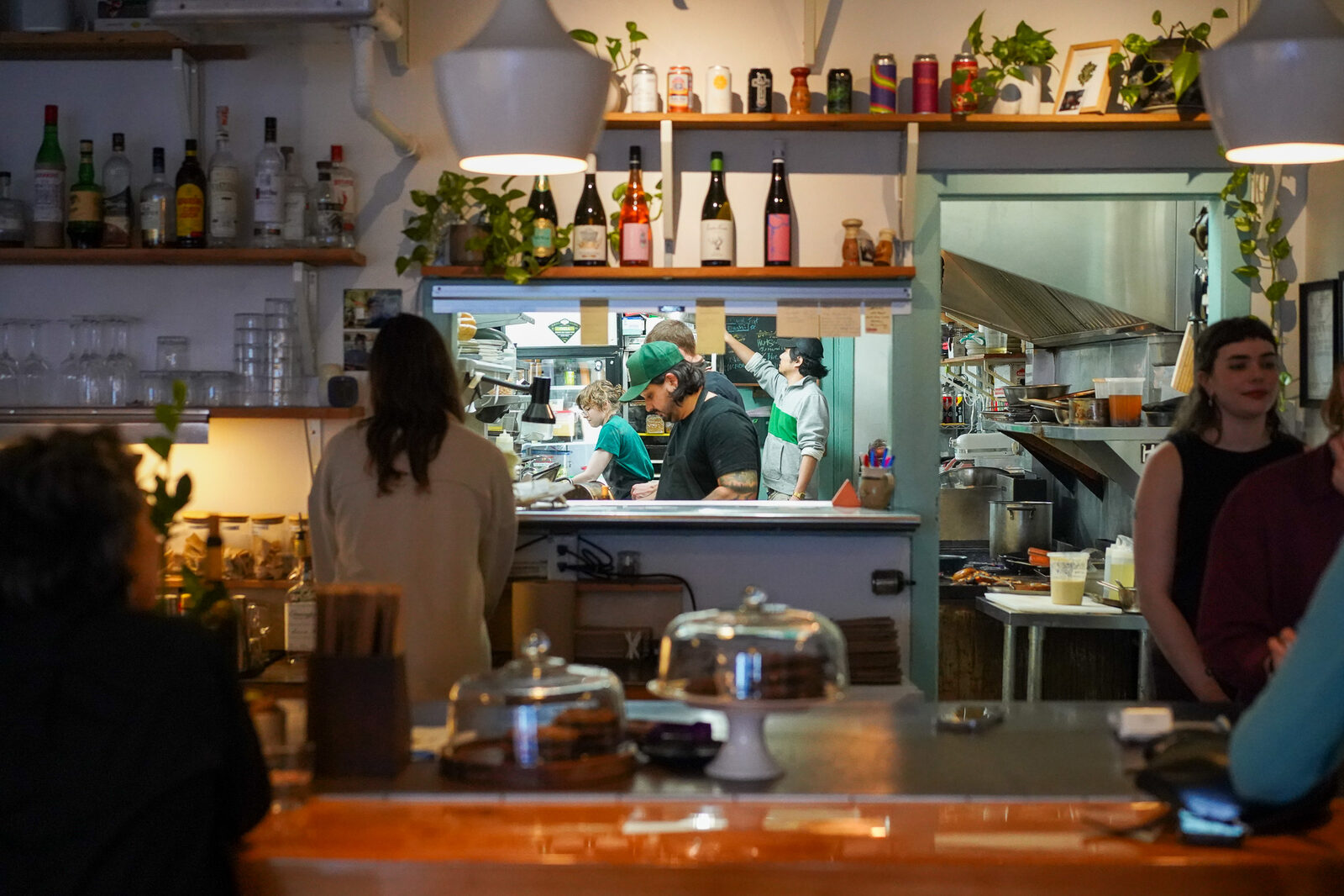 Inside Part & Parcel in Quadra Village, with the team at work behind the bar.